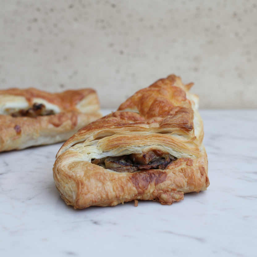 Vegetarian savoury puff pastry with mushrooms, onions, and cheese from Prestige Patisserie, North London.