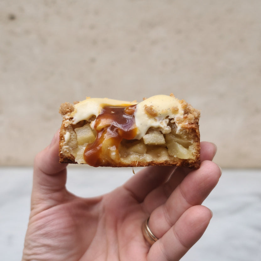 Apple crumble tart with golden shortbread crust, vanilla cream and caramel drizzle
