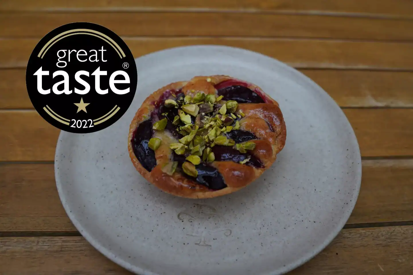 Plum and pistachio frangipane tart handmade in North London patisserie