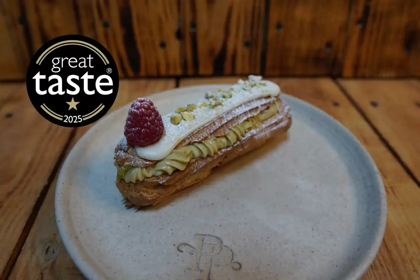 Pistachio and raspberry éclair handmade in North London patisserie